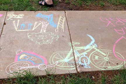 Bike and playground, drawn on the sidewalk.